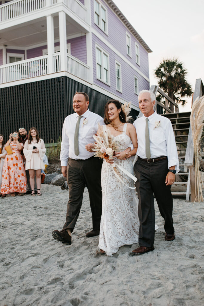 Happy bride as she walks down the aisle to her awaiting groom