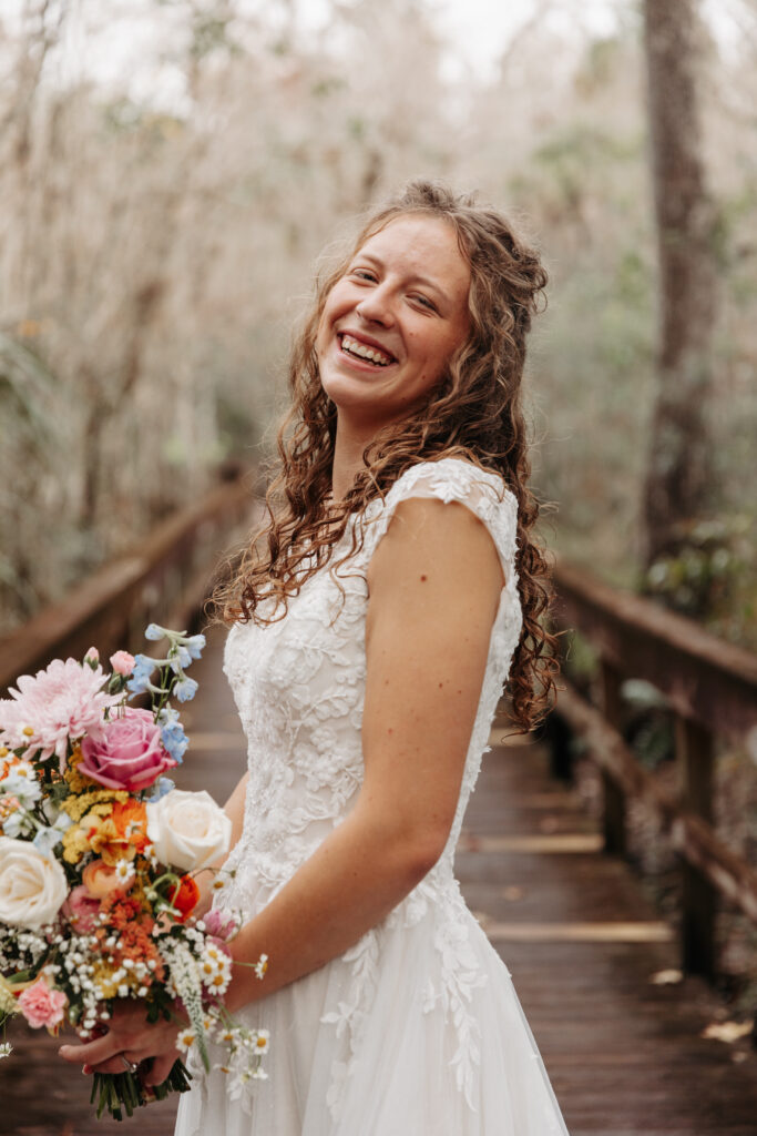 Bride with a brightly colored bouquet at Highlands Hammock State Park.