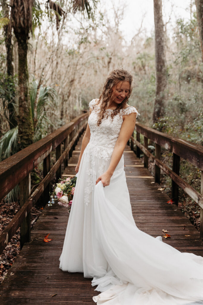 Bride playing with her dress at Highlands Hammock State Park.