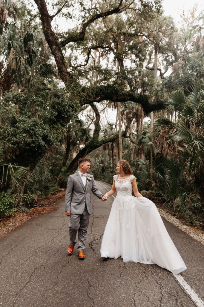 Bride and groom walking down the road at Highlands Hammock State Park.