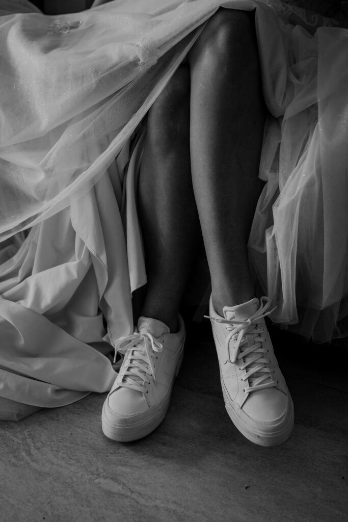 bride showing off her white sneakers