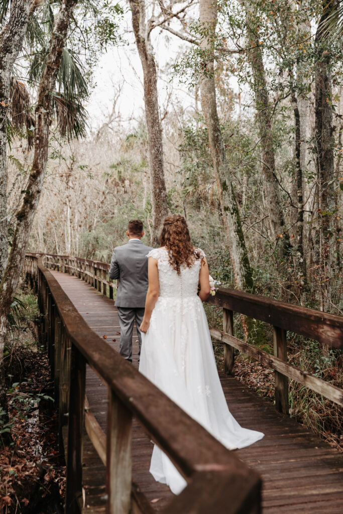 bride walking up to her groom at Highlands Hammock State Park for a first look.