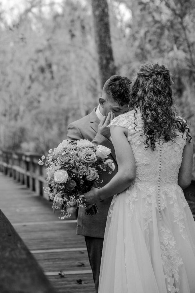 Groom tearing up during his first look with his bride at Highlands Hammock State Park.