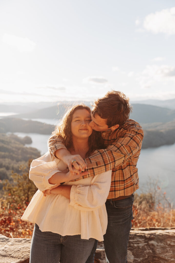 Engaged couple at Lake Jocassee Overlook at sunset