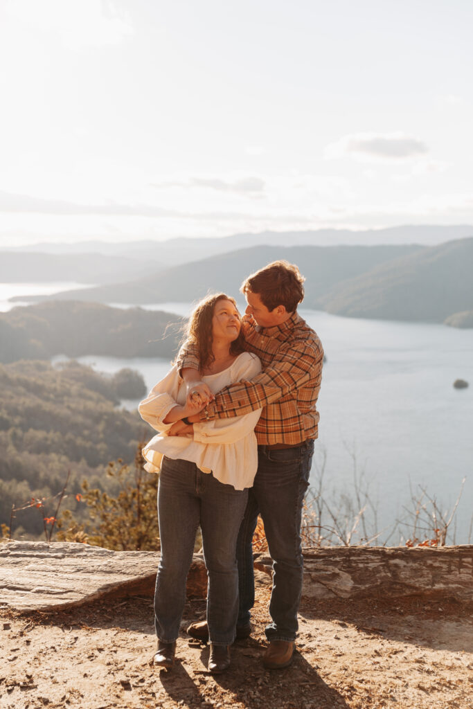 Engaged couple at Lake Jocassee Overlook at sunset