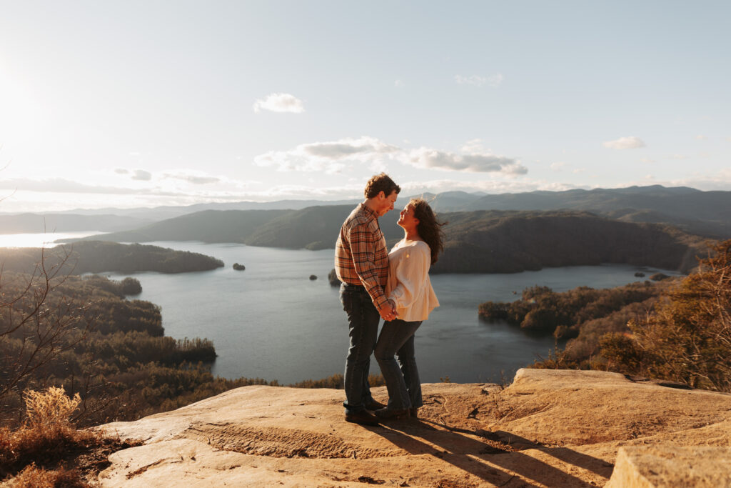 Engaged couple at Lake Jocassee Overlook at sunset