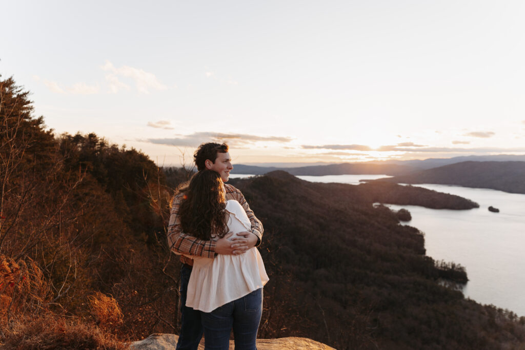 Engaged couple at Lake Jocassee Overlook at sunset