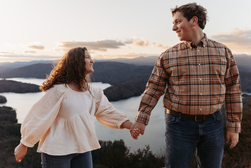 Engaged couple at Lake Jocassee Overlook at sunset
