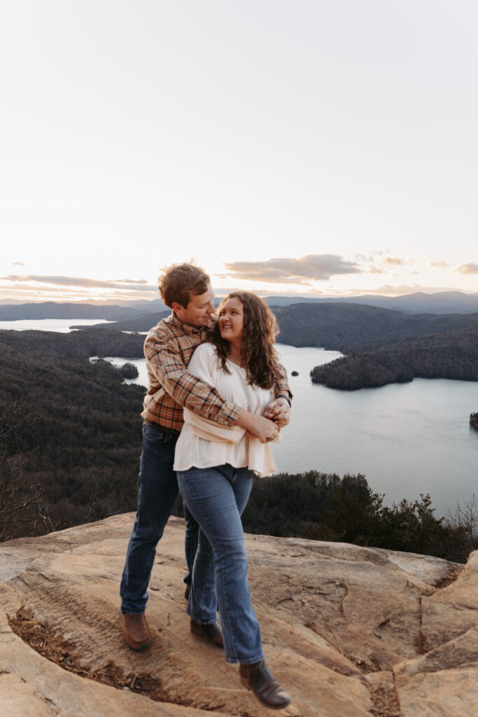 Engaged couple at Lake Jocassee Overlook at sunset