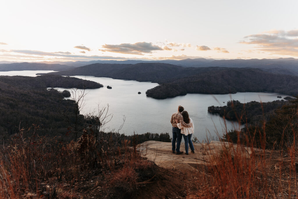 Engaged couple at Lake Jocassee Overlook at sunset