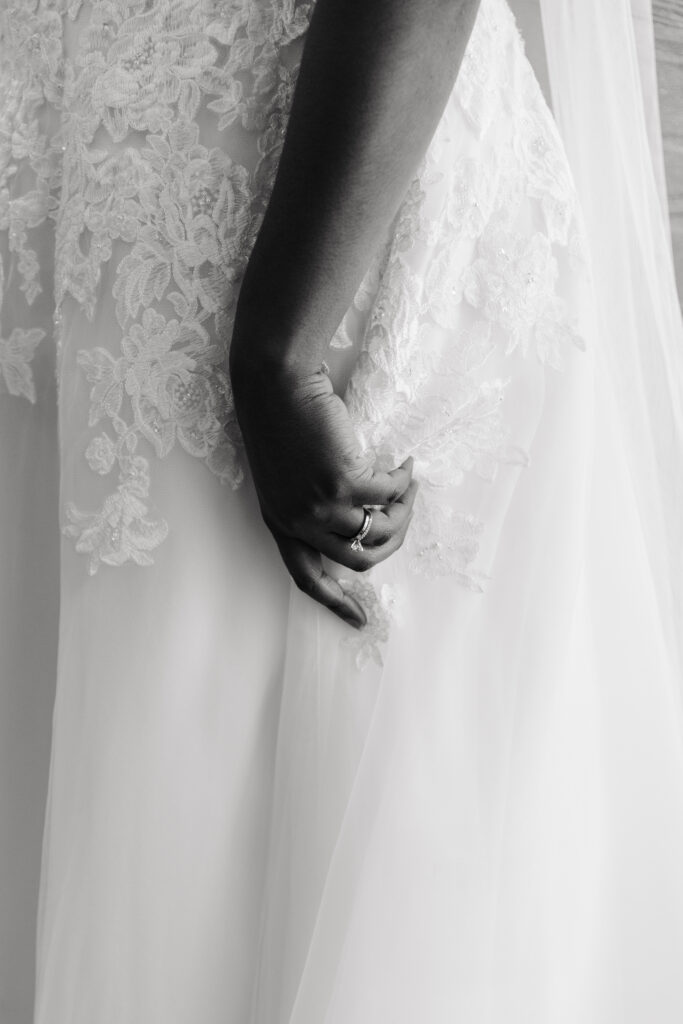 bride holding her lace gown