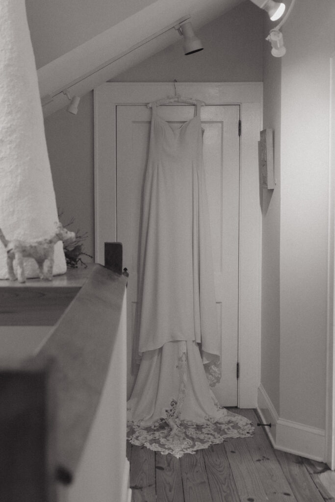 Wedding dress hanging in doorway in an art studio