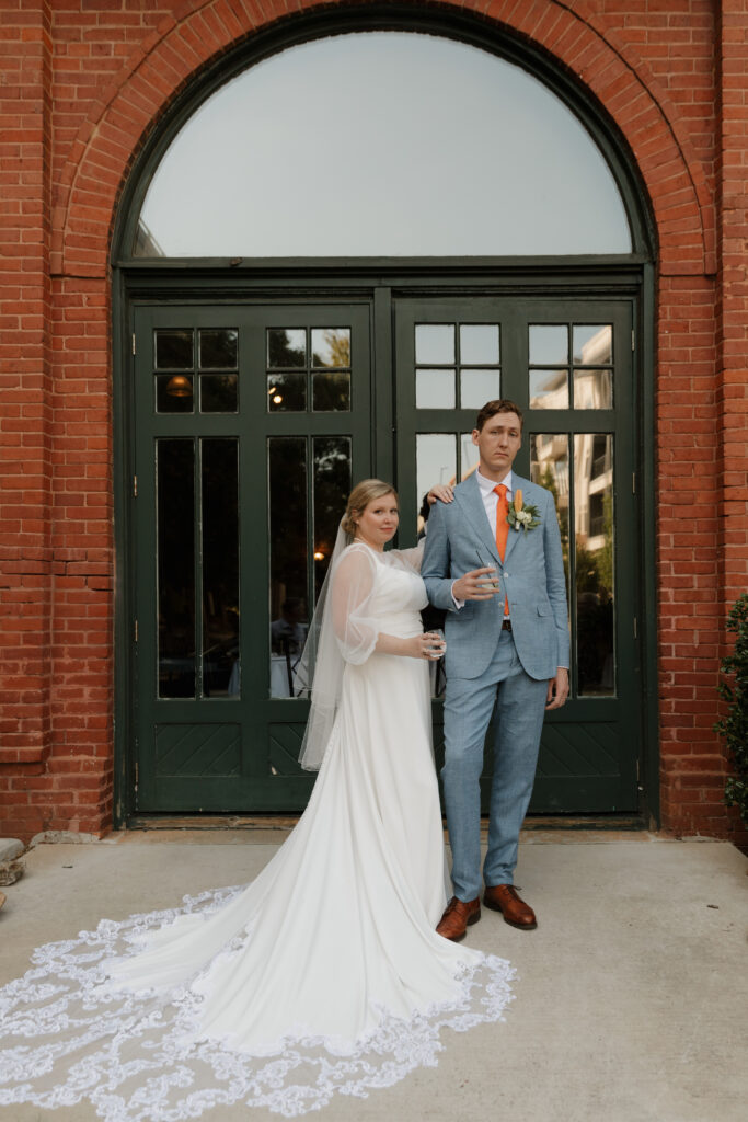 Bride and groom during cocktail hour at their wedding reception at The L in downtown Greenville, SC.
