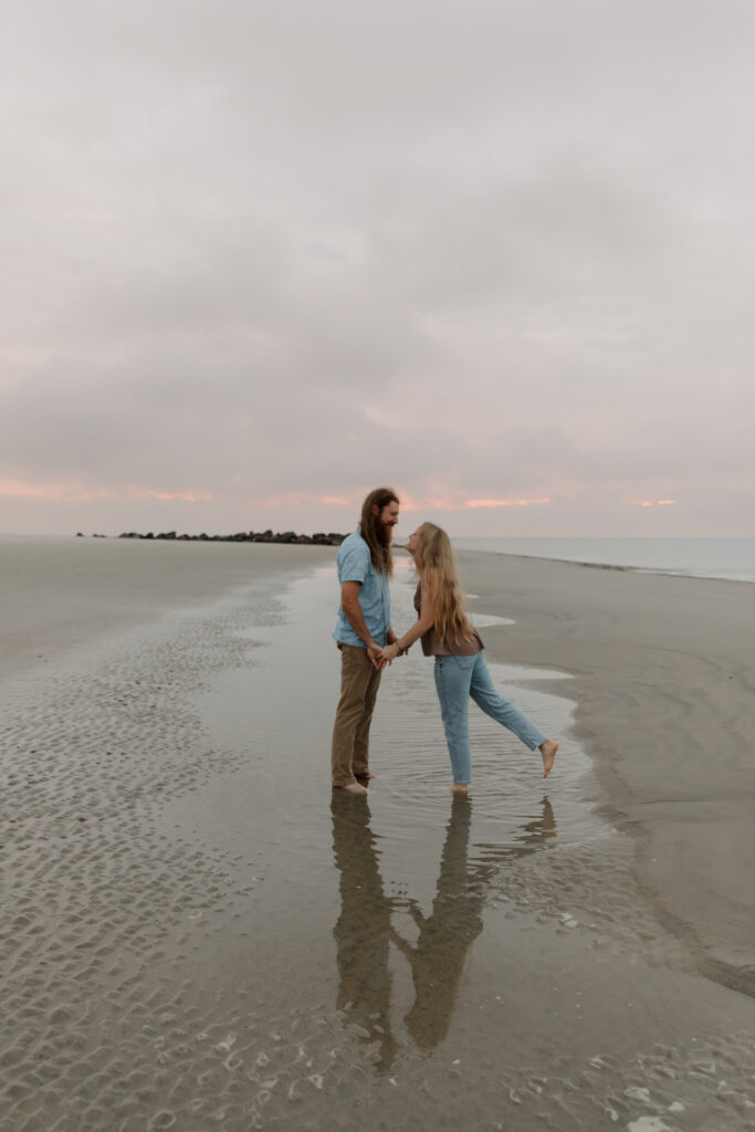 A cloudy sunrise engagement session at Folly Beach in South Carolina.