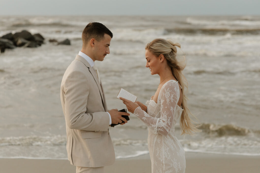 Bride and groom reading vows to each other during their elopement on Folly Beach in South Carolina.