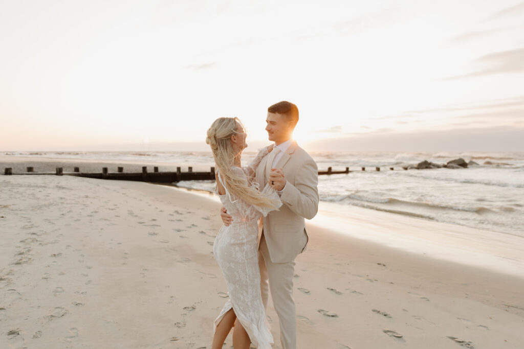 Bride and groom dancing on the beach during their sunrise elopement on Folly Beach in South Carolina.