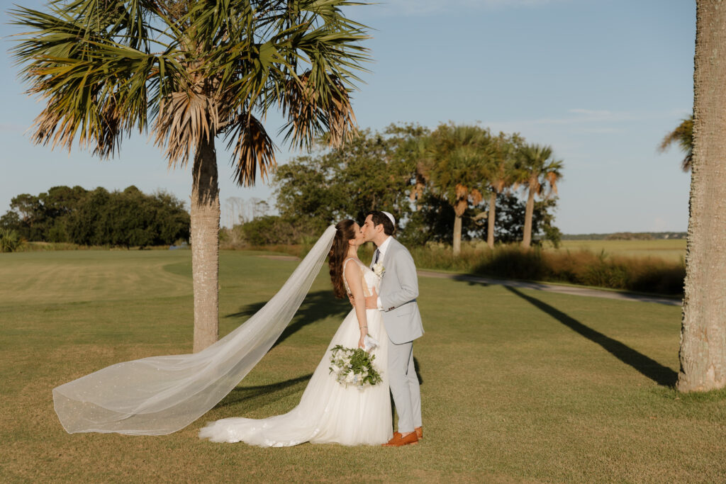 Jewish bride and groom sharing a kiss after their wedding ceremony at The Golf Club at Briar's Creek on Johns Island, SC.