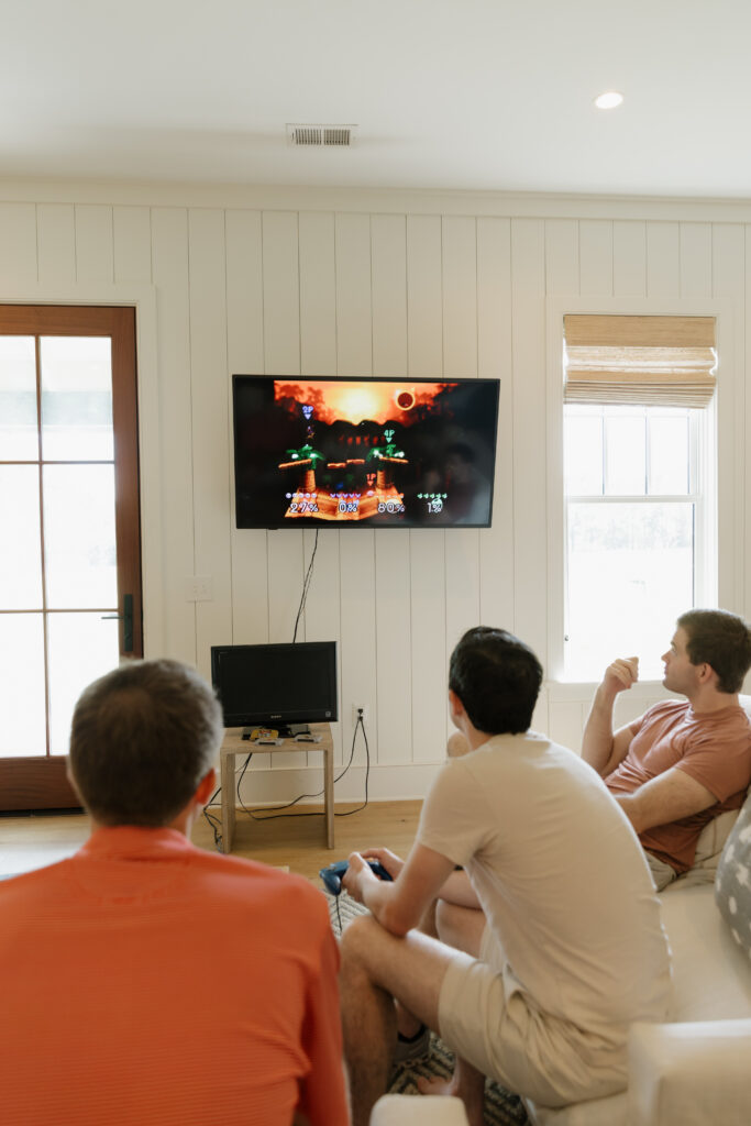 Groom and his friends playing an old school Nintendo before getting ready for the wedding.